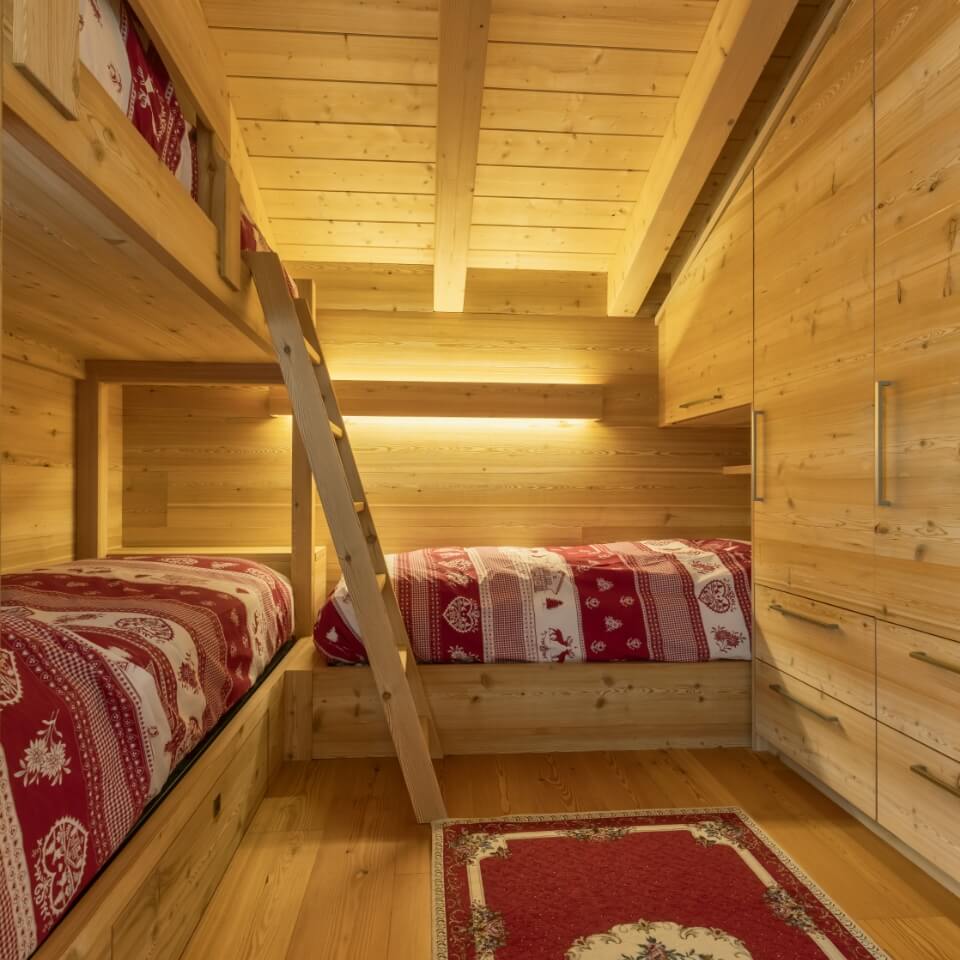 Cameretta completamente rivestita in legno con armadi capienti e 3 letti